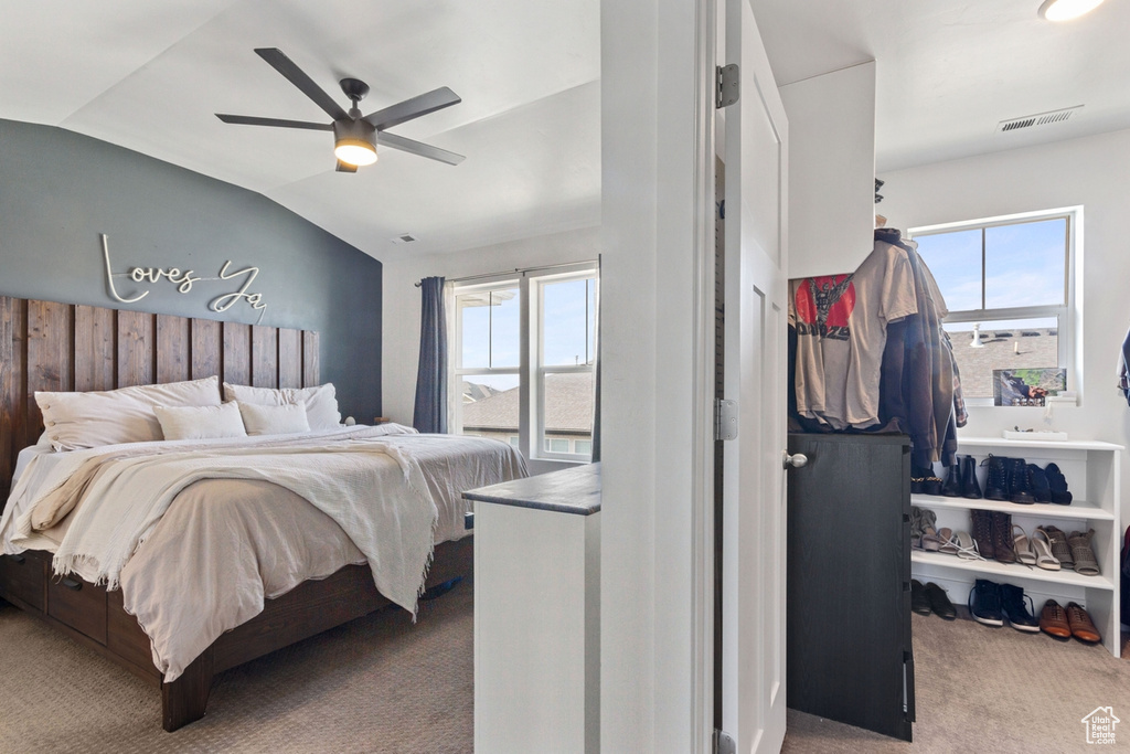 Bedroom with carpet floors, lofted ceiling, and a ceiling fan