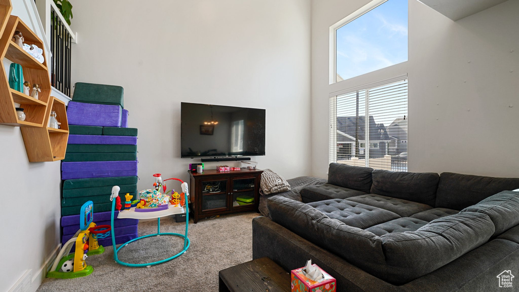 Living room featuring a high ceiling and carpet floors