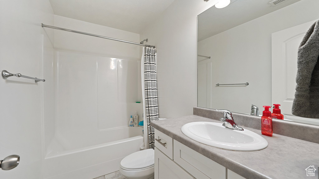 Bathroom featuring shower / tub combo with curtain, vanity, visible vents, and toilet