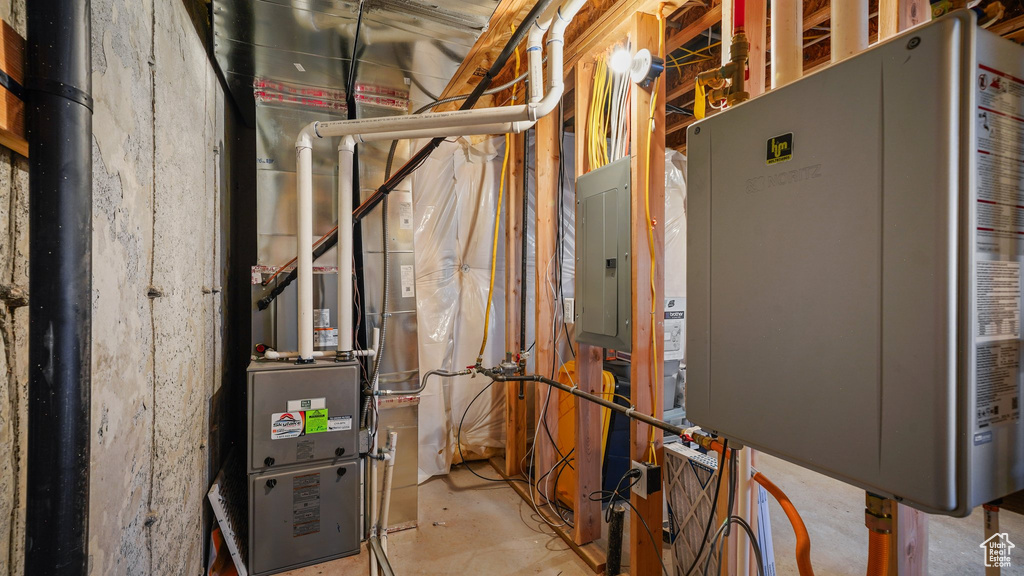 Utility room featuring water heater and electric panel