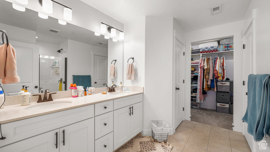 Full bathroom with tile patterned floors, visible vents, and a sink