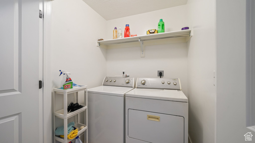 Washroom featuring laundry area and washer and clothes dryer