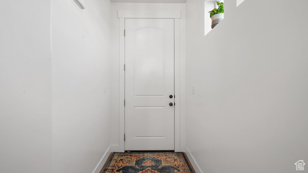 Doorway to outside with baseboards
