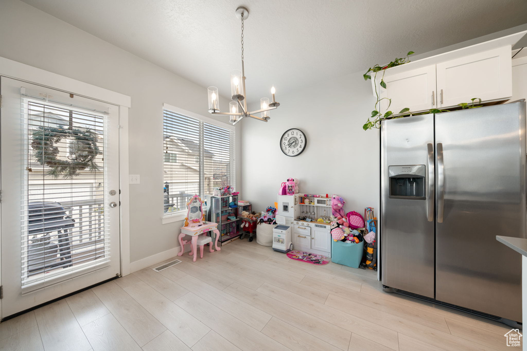 Game room with light wood-style floors, a notable chandelier, baseboards, and visible vents