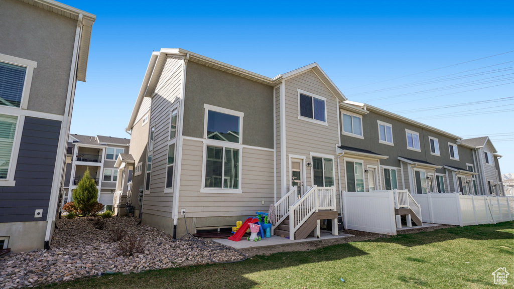 View of front of home with a front lawn and fence