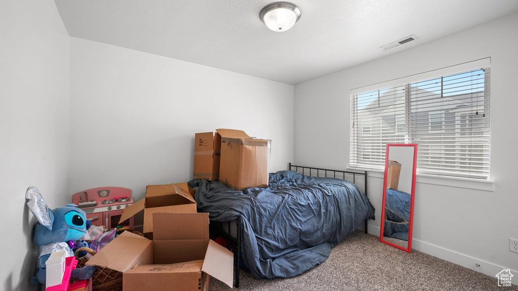 Bedroom featuring carpet, visible vents, and baseboards