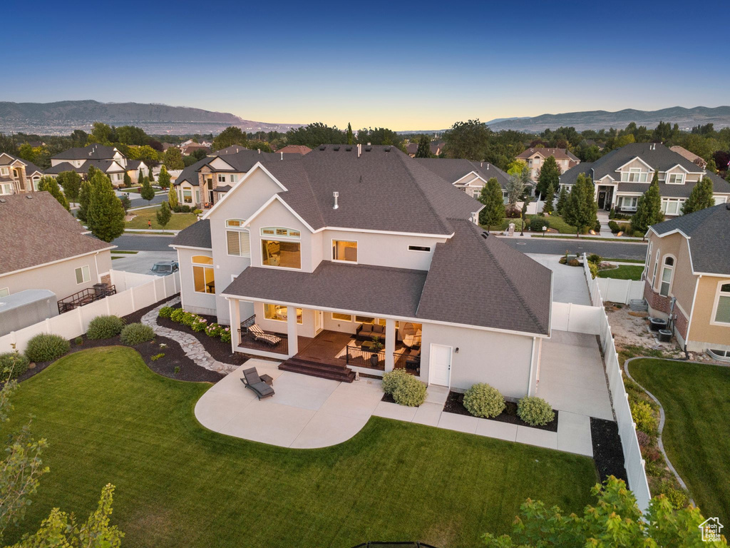 Back of property featuring roof with shingles, a residential view, and a fenced backyard