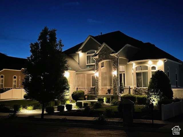 French country inspired facade with stone siding and stucco siding