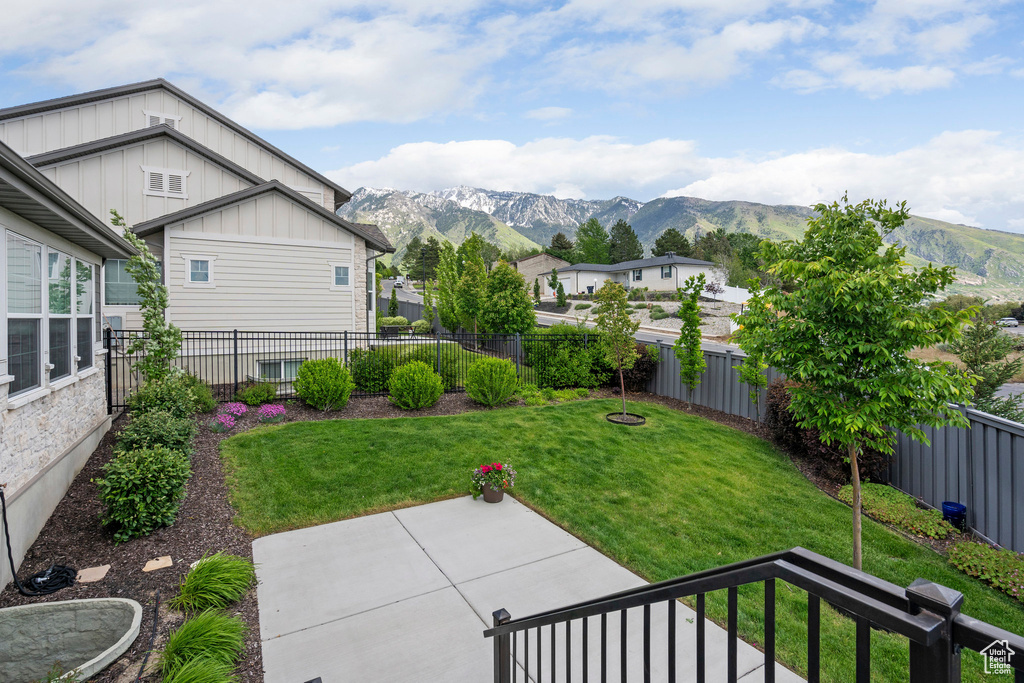 View of yard with a mountain view, a residential view, and a patio