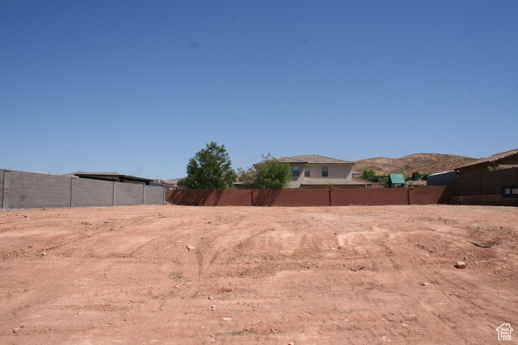 View of yard with a mountain view and fence