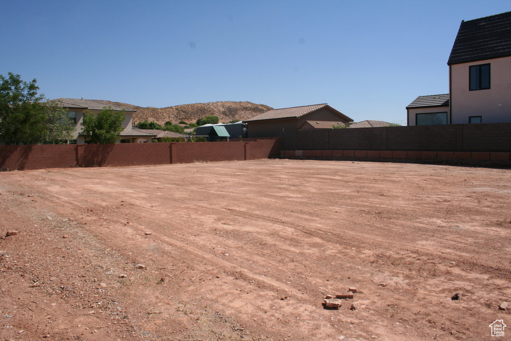 View of yard featuring a mountain view and fence