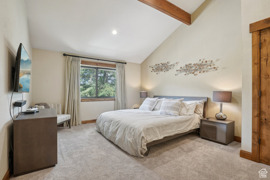 Bedroom featuring high vaulted ceiling, baseboards, beamed ceiling, and carpet floors