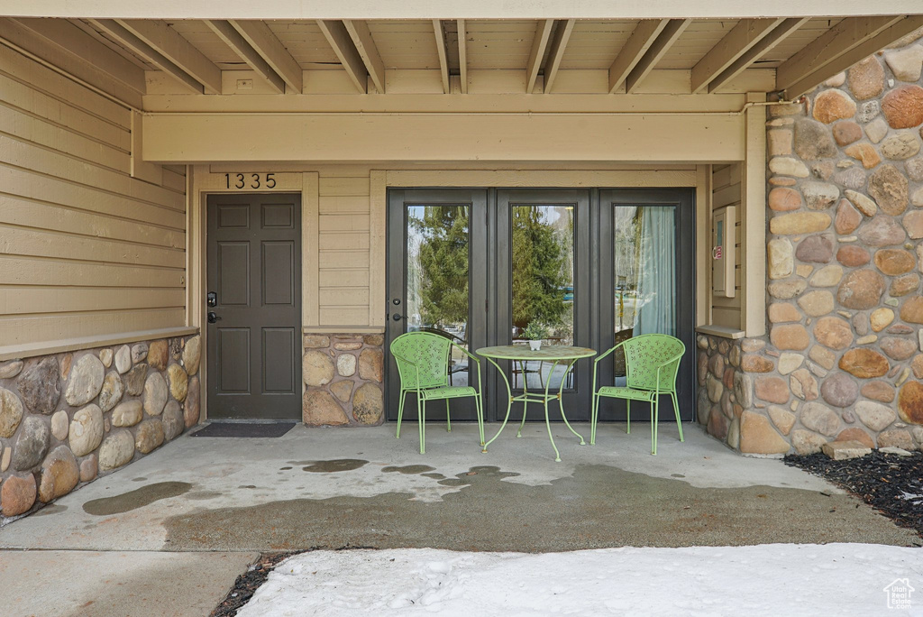 Doorway to property with french doors and stone siding