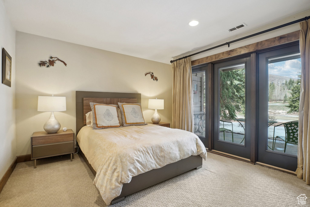 Bedroom featuring visible vents, carpet floors, access to exterior, and baseboards