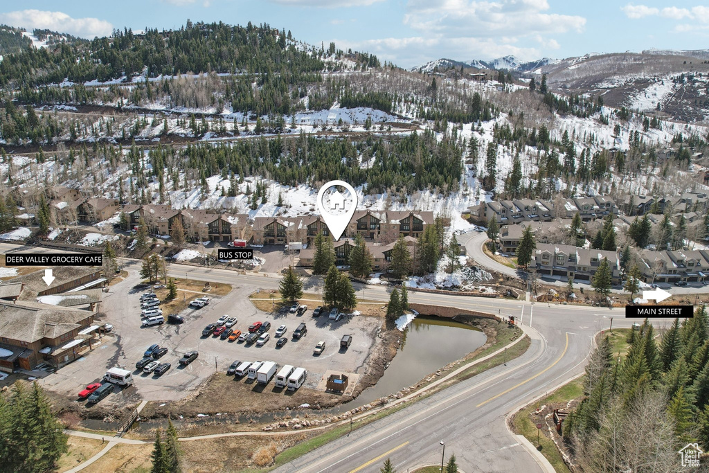 Snowy aerial view featuring a residential view and a mountain view