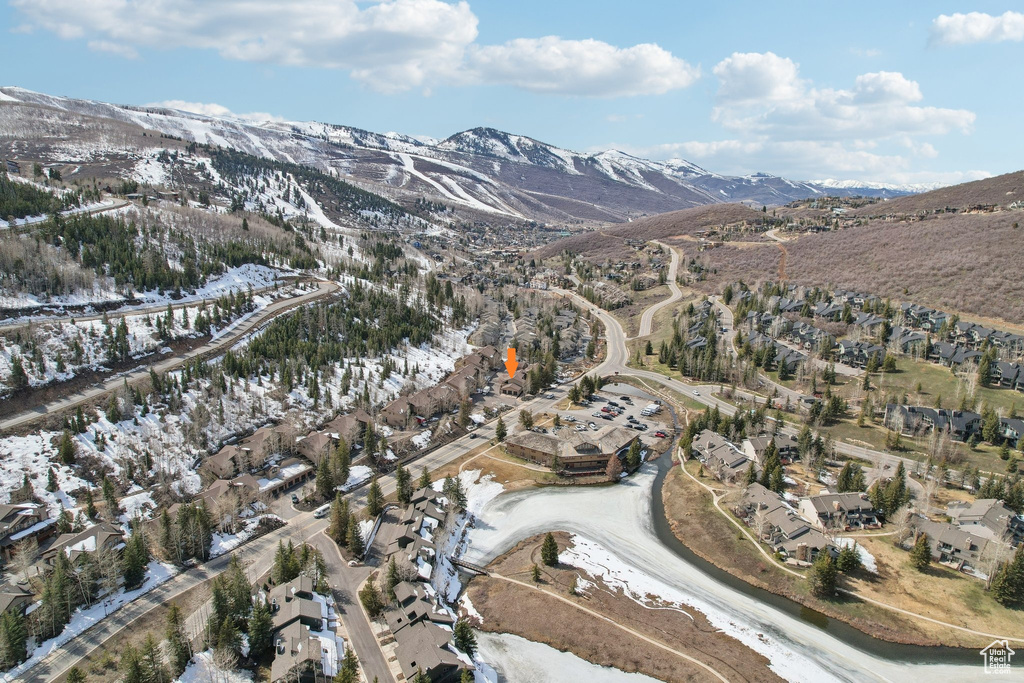 Snowy aerial view featuring a mountain view and a residential view