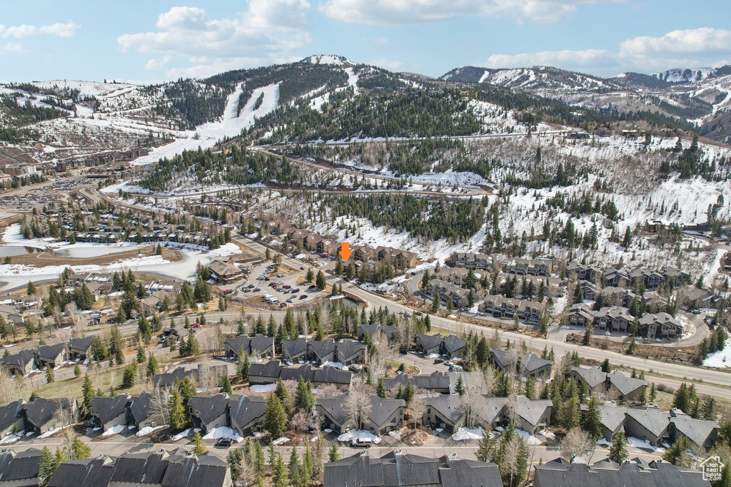 Snowy aerial view with a mountain view and a residential view