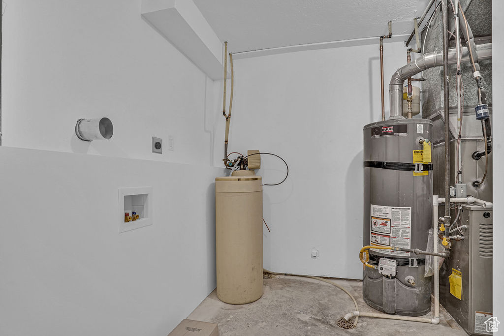 Utility room featuring secured water heater