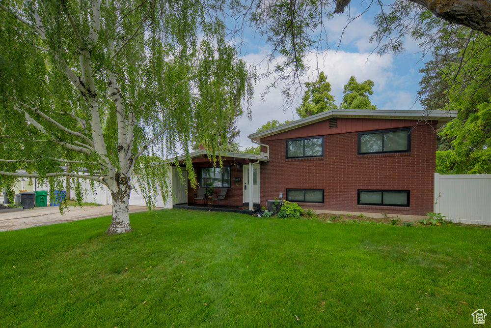 Split level home with brick siding and driveway