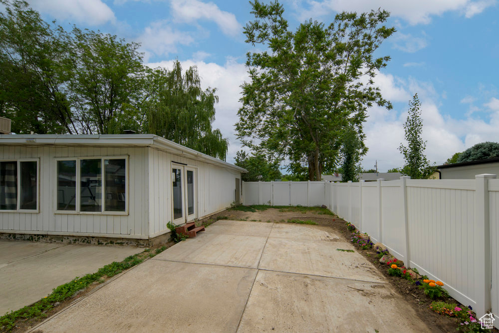 Fenced backyard featuring a patio