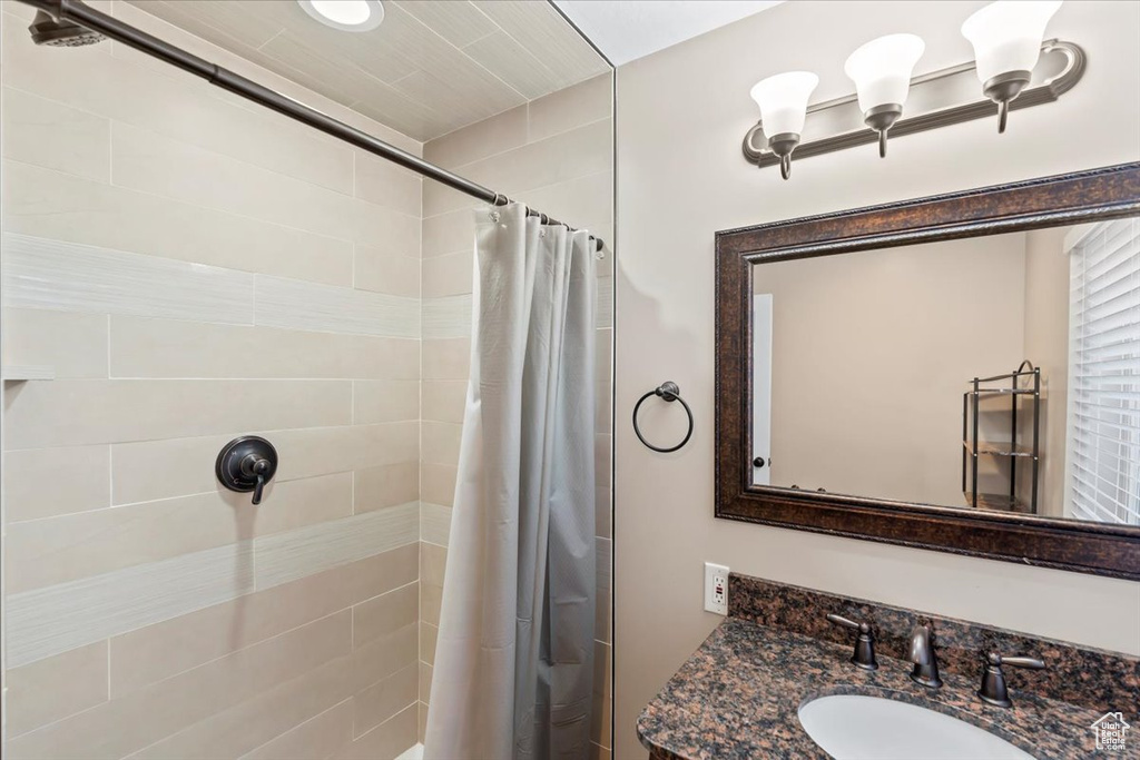Bathroom with a tile shower and vanity