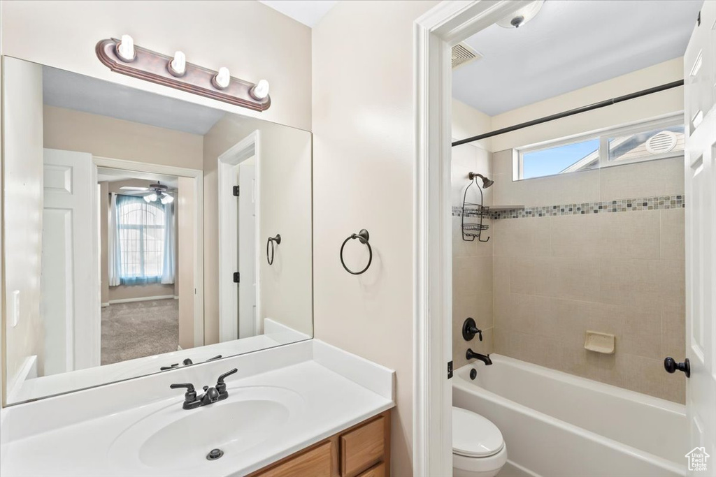 Bathroom featuring bathing tub / shower combination, vanity, visible vents, and toilet
