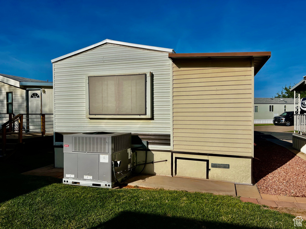 View of home's exterior with cooling unit