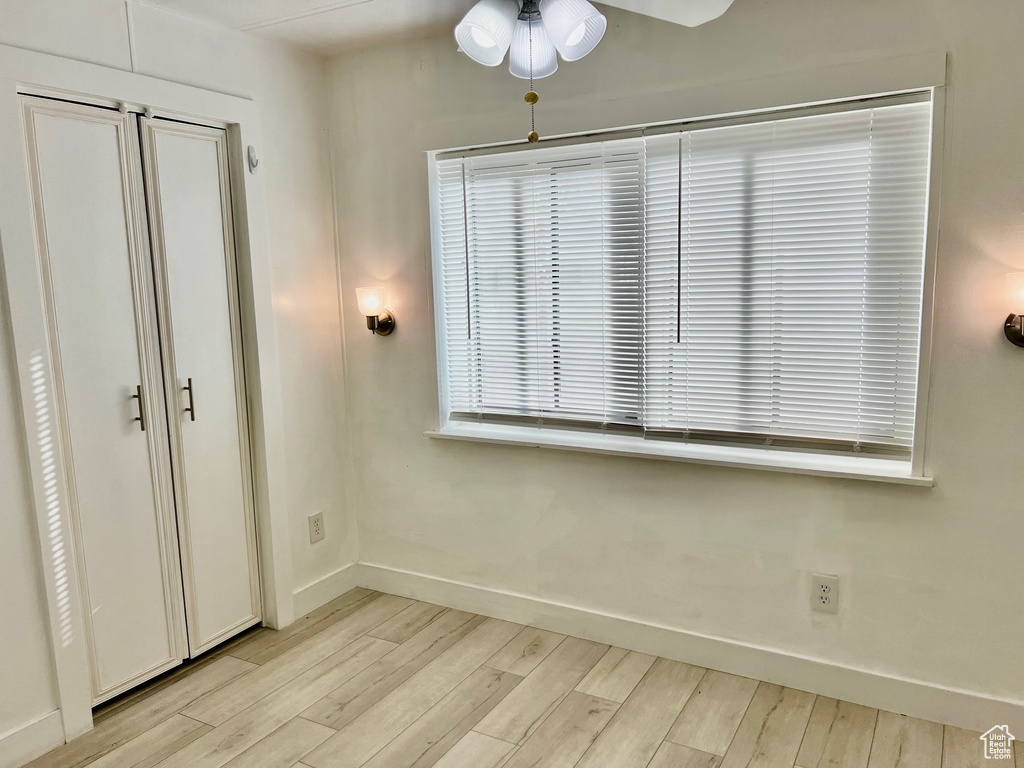Unfurnished bedroom featuring baseboards, light wood finished floors, and ceiling fan