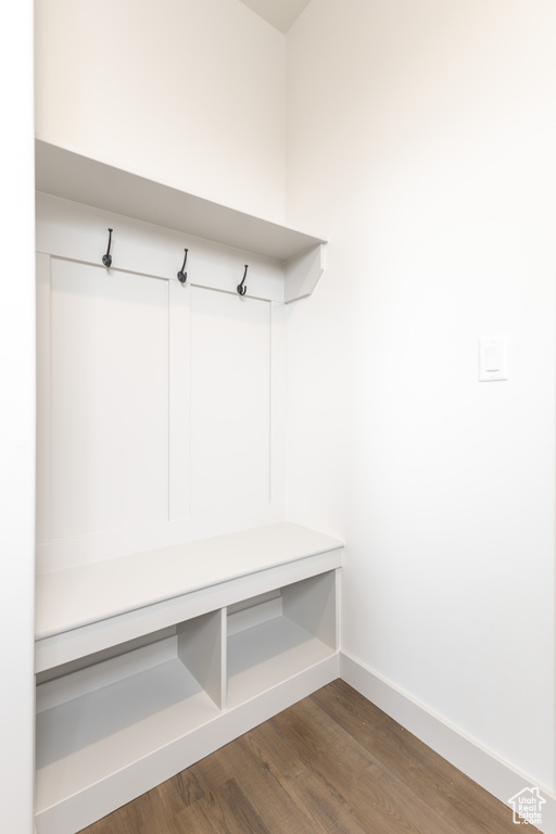 Mudroom with wood finished floors and baseboards