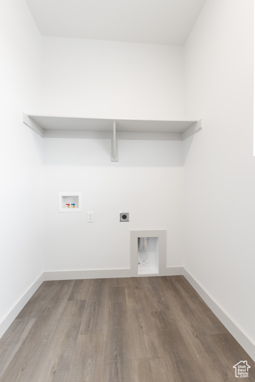 Laundry area with hookup for an electric dryer, baseboards, washer hookup, laundry area, and wood finished floors