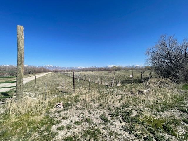 View of yard featuring a rural view and fence