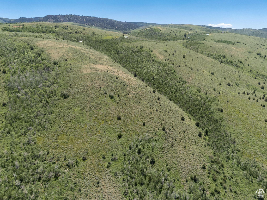 Aerial view of property and surrounding area with a mountainous background