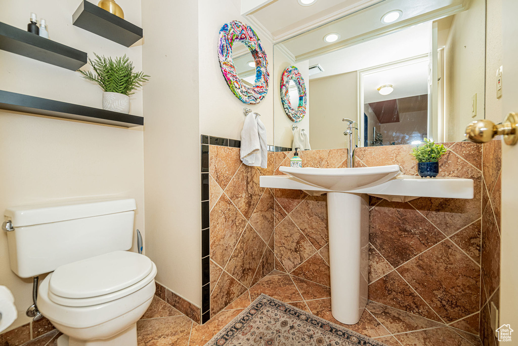 Half bath featuring toilet and recessed lighting