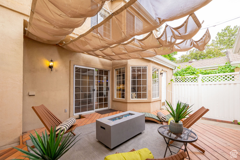View of patio / terrace featuring a fire pit and a deck
