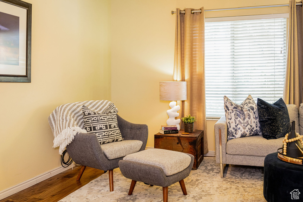 Sitting room with wood finished floors and baseboards