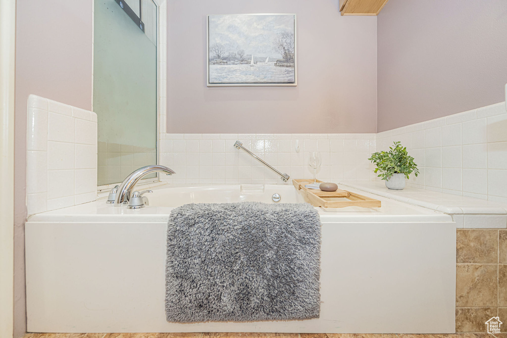 Full bath featuring a bath