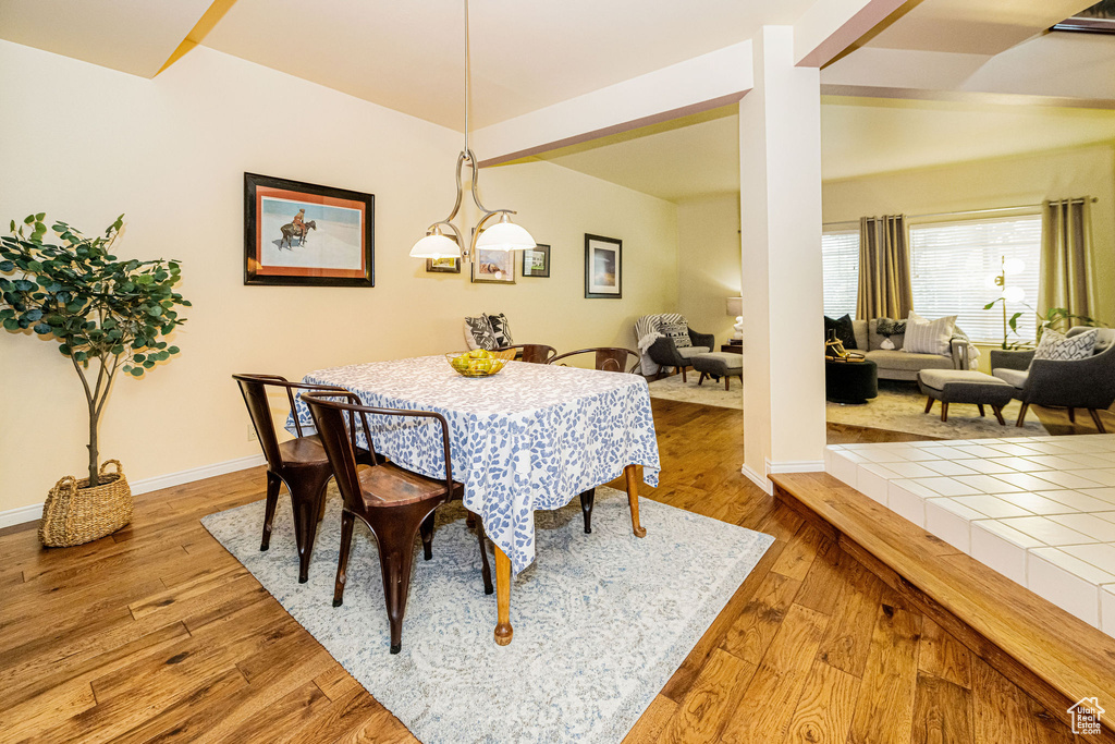 Dining room with hardwood / wood-style floors and baseboards