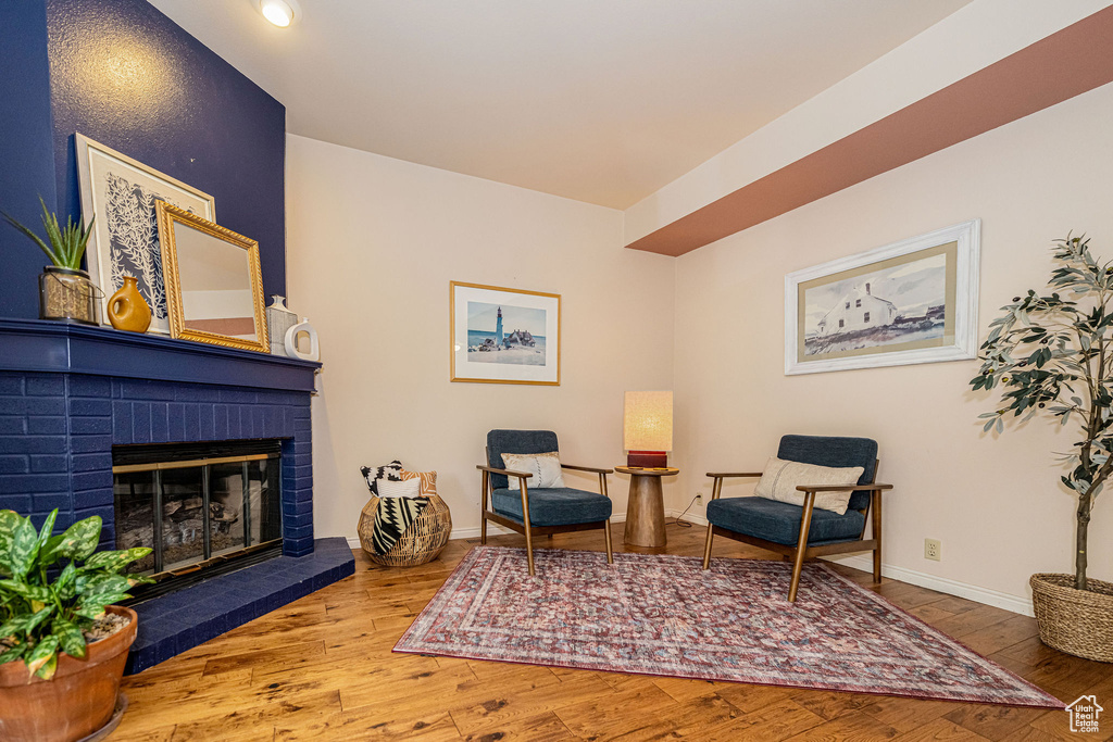 Living area with wood finished floors and a fireplace