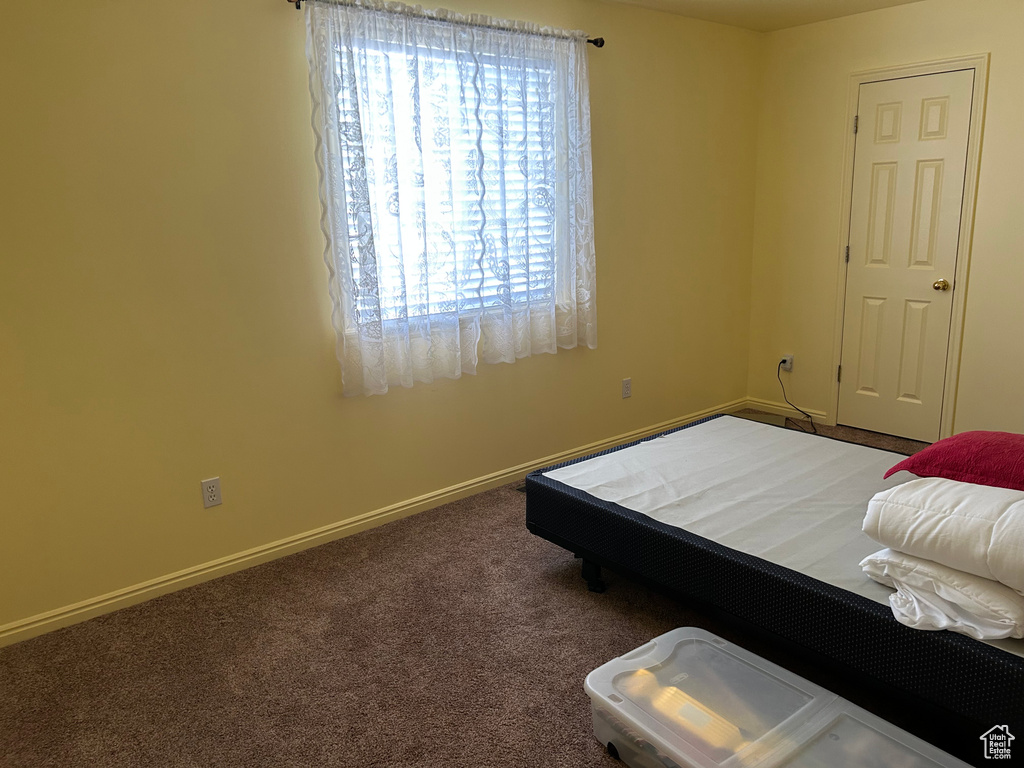 Bedroom featuring carpet flooring and baseboards