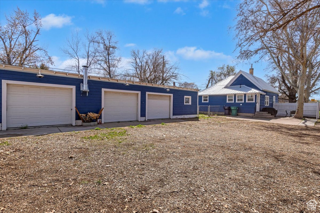 Detached garage featuring fence