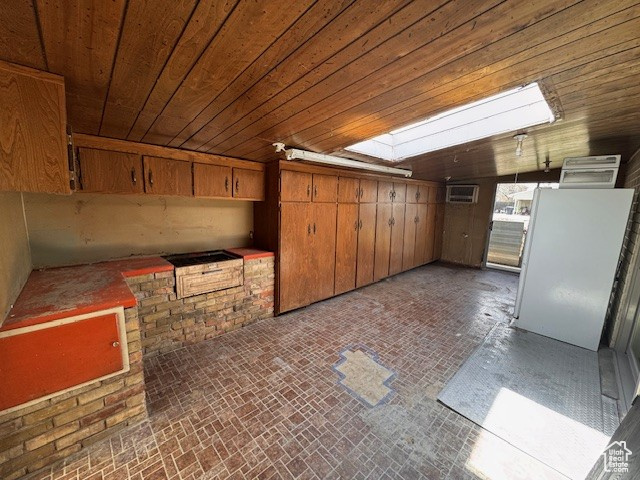 Kitchen with brick floor, wood ceiling, brown cabinetry, and a skylight