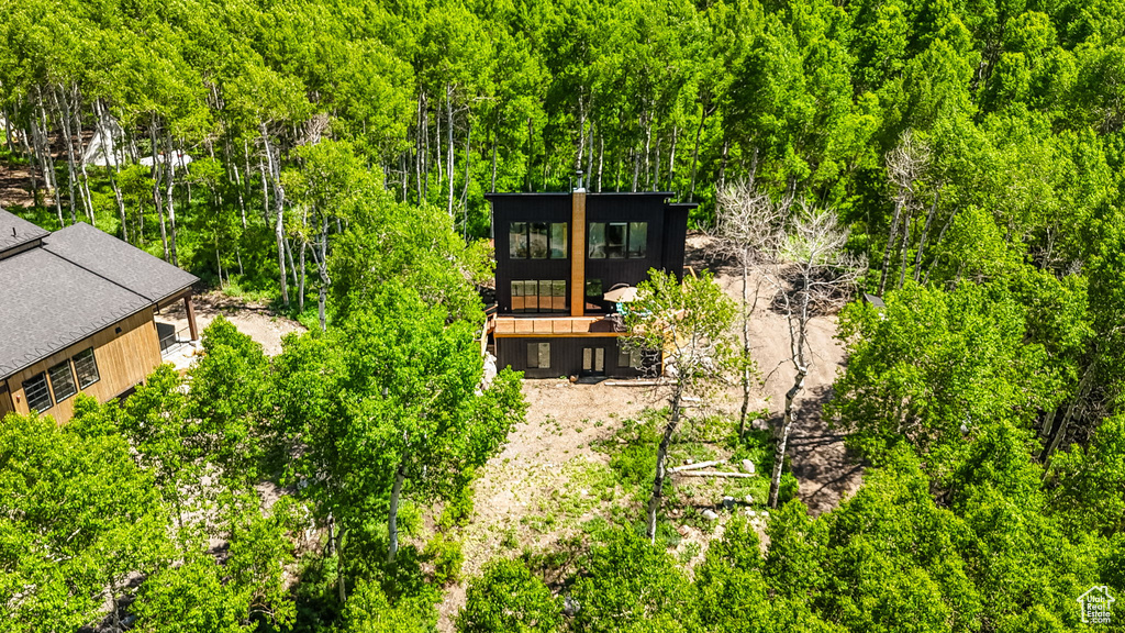 View of subject property featuring a forest