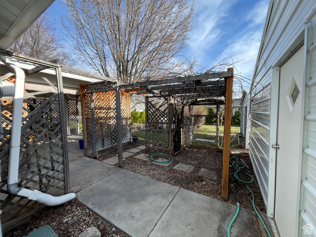 View of patio with a pergola and fence