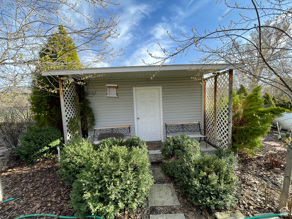 View of outdoor structure featuring covered porch