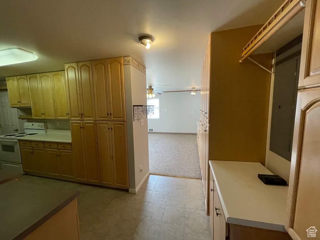 Kitchen with baseboards, a ceiling fan, and white electric range