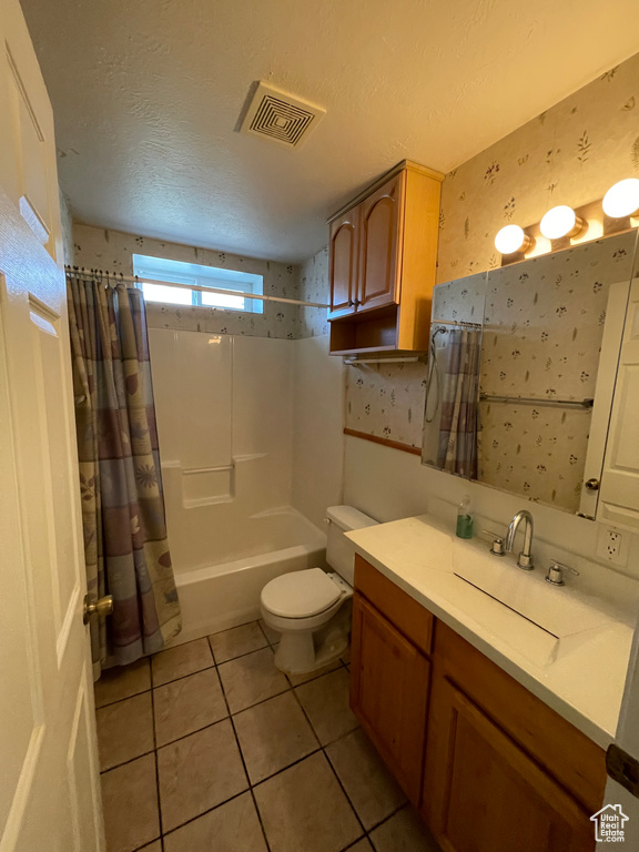 Full bath with vanity, tile patterned flooring, visible vents, toilet, and wallpapered walls