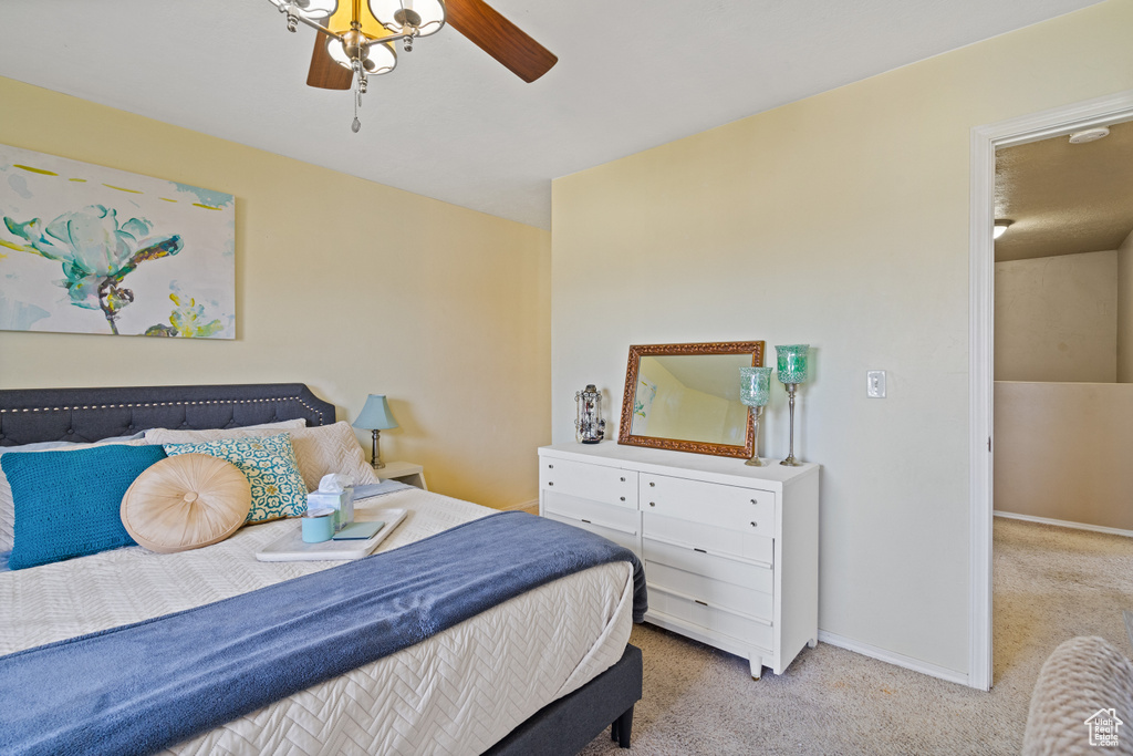 Bedroom with carpet flooring, baseboards, and a ceiling fan