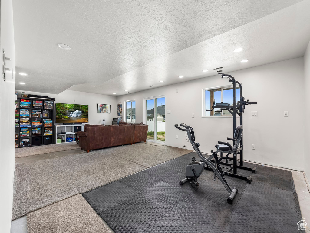 Workout room with recessed lighting and a textured ceiling