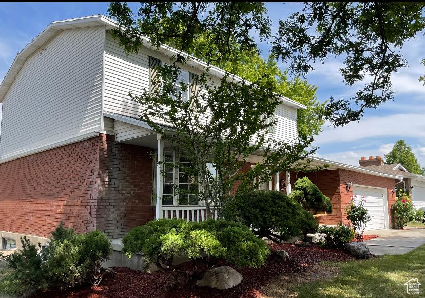 View of property exterior with brick siding and an attached garage