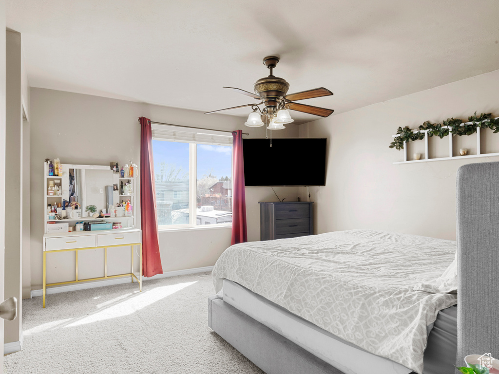 Carpeted bedroom with baseboards and ceiling fan